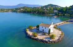 an island with a house on it in the middle of water