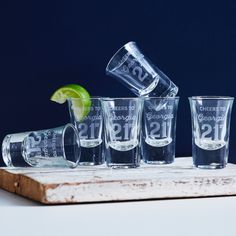 the shot glasses are lined up next to each other with lime wedges in them