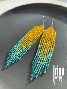 yellow and blue beaded earrings on a plate