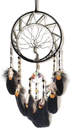 a black and white dream catcher with feathers