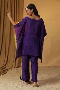 Purple color block kaftan with floral hand painted motif and tasselled embroidery. Paired with coordinating pant. - Aza Fashions Multicolor Traditional Kaftan For Diwali, Traditional Multicolor Kaftan With Tassels, Silk Kaftan With Tassels, Traditional Purple Short Sleeve Kaftan, Traditional Purple Silk Kaftan, Purple Flowy Bohemian Kaftan, Festive Purple Silk Kaftan, Festive Silk Purple Kaftan, Festive Embroidered Purple Kaftan