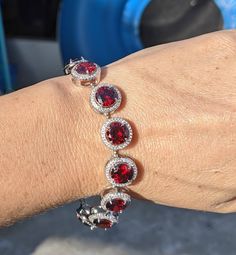 "Garnets were tested and examined by a professional gemologist using professional equipment.  Valued at $670 ( silver zircon option) An appraisal can be purchased for an extra 50$ The pictures don't do this justice it is are absolutely breathtaking. Your heart will melt You will love these flawless red garnet chunky iced bracelet. It sparkles and reflects light beautifully.  The AAA CZ halo gives this bracelet an extra glisten. Making bracelet look elegant and expensive. Natural Garnet is deep r Dark Garnet, Chunky Bracelet, Garnet Bracelet, Garnet Pendant, Chunky Bracelets, January Birthstone, Jewelry For Her, Red Garnet, Tennis Bracelet