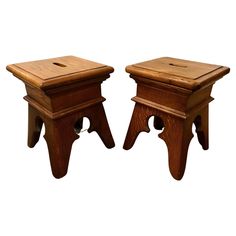 two wooden stools sitting next to each other on top of a white background,