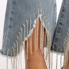 Description: Solid High Rise, Cropped, Slim Fit Jean With A 4-Fly Button With Stunning Rhinestone Fringe Detail Wide Leg Bottoms With Rhinestones For Spring, Spring Wide-leg Bottoms With Rhinestones, Wide-leg Rhinestone Bottoms For Spring, Chic Denim Blue Jeans For Party, Elegant Rhinestone-embellished Bottoms For Spring, Elegant Rhinestone Bottoms For Spring, Embellished Denim Blue Straight Leg Bottoms, Trendy Denim Blue Bottoms With Rhinestones, Spring Denim Blue Bottoms With Rhinestones