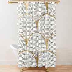 a white shower curtain with gold foilwork and dots on it, in front of a bathtub