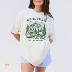 Seek adventure in Asheville, North Carolina! This comfort colors tee features majestic Blue Ridge Mountains and a camping scene - perfect for granola girls, nature lovers, and anyone who loves exploring Asheville's outdoors. Prefer this design on a long-sleeve t-shirt? Visit this link: https://bohemianbloomdesigns.etsy.com/listing/1736756463 👕 T-Shirt Brand Comfort Colors 1717 | Unisex Adult Sizing | 100% Ring-Spun US Cotton ⏳🚚 Production & Shipping All items are made-to-order. They will ship within 1-5 business days from one of our printing partners, shipping usually takes between 2-5 business days after the item is shipped. Please allow sufficient time for production and shipping.  Important: Please double-check your shipping address before checking out. A fee will apply if an order ne Graphic Tee T-shirt With Relaxed Fit For Camping, Graphic Tee With Relaxed Fit For Camping, Crew Neck Shirt With Graphic Print For Camping, Relaxed Fit Screen Print T-shirt For Camping, Cotton Camp Shirt With Graphic Print For Outdoor Activities, Cotton Graphic Print Camp Shirt For Outdoor Activities, Casual Graphic Print Camp Shirt, Casual T-shirt For Camping, Relaxed Fit Letter Print T-shirt For Camping