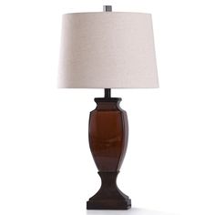 a brown table lamp with a white shade