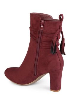 Show off chic style in ankle wrapped booties by Journee Collection. These booties feature premium faux suede uppers that rise above the ankles. A stylish tasseled strap wraps around the ankles and chunky high-heels complete the design . Round toe. Inner zip closure. Tassel trim. Approx. 3" heel height. Approx. 8.5" shaft height, 10" opening circumference. Imported Faux suede upper, rubber sole Chic Fringe Boots For Winter, Trendy Boots With Tassels For Fall, Winter Suede Boots With Tassels, Chunky High Heels, Rise Above, Women Boots, Journee Collection, Ankle Bootie, Ankle Booties