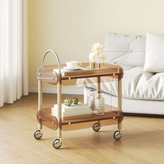 a living room with a couch, coffee table and two books on the cart in front of it