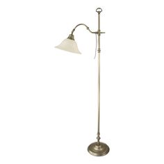 a floor lamp with a white shade on it's arm and a metal base