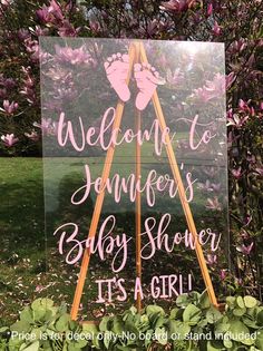 a sign that says welcome to the baby shower it's a girl in pink