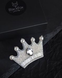 This gorgeous brooch in the form of silver crown is unique piece of jewelry for the real queens. You will always be in the spotlight with this brooch. Purchase this shiny brooch as a gift for yourself or your dear person and I guarantee it will exceed your expectations! This beaded brooch is embroidered with silver seed beads, Austrian premium quality crystal and pearls. Each element of brooch is securely sewn by hand. The reverse side is covered with silver genuine leather. Japanese smooth pin Cheap Handmade Brooches As Gifts, Beaded Crown Brooch, Silver Embellished Wedding Brooches, Handmade Pinched Crown As A Gift, Handmade Pinched Crown As Gift, Elegant Round Crown For Gift, Beaded Crown, Heart Crown, Real Queens