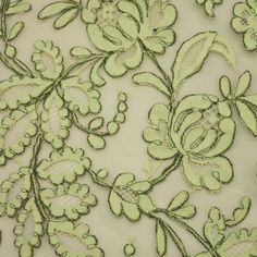 an embroidered fabric with green flowers and leaves on white background, closeup view from the bottom