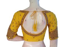 Make a Statement With this yellow color semi silk blouse, adorned with intricate Aari hand embroidery! This stunning piece combines traditional Indian techniques with modern style. Perfect for special occasions or adding a touch of elegance to your everyday look. * This Is A Fully Stitched Saree Blouse, Ready To Wear * Made of Semi silk, Lined With Cotton * Opens From Front With Hook and eye-fitting MEASUREMENTS: Sleeve: 10 inches  Size: 38,40,42 Blouse Length: 15.5 inches  Neck depth: 7 inches Luxury Yellow Blouse With Self Design, Yellow Blouse With Resham Embroidery For Navratri, Yellow Resham Embroidery Blouse For Navratri, Traditional Yellow Blouse For Wedding, Yellow Blouse For Transitional Wedding Season, Elegant Yellow Festive Blouse, Yellow Resham Embroidery Blouse Piece For Diwali, Anarkali Yellow Blouse With Resham Embroidery, Yellow Anarkali Blouse With Resham Embroidery