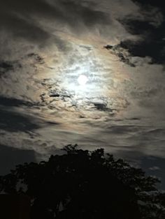 the moon is shining brightly in the cloudy sky