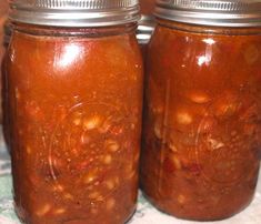 two jars filled with food sitting on top of a table