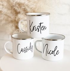 three white coffee mugs with the words kristen and nicole written in black ink