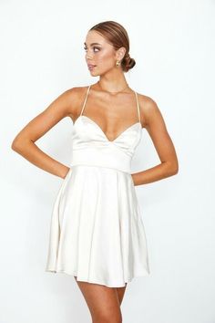 If you're looking for a fresh and approachable dress, the Aphrodite Champagne Satin Bustier Dress has you covered. It's great for a semi-formal occasion with its fitted bodice, plunge neckline, open back, and fit and flare silhouette. The champagne satin fabric gives it an unexpected touch of elegance you'll love. You can pair this dress with strappy high-heeled sandals and make a statement with a statement necklace. One to add to your wardrobe! DETAILS & CARE Polyester. Dry Clean. Imported. Cute Graduation Outfits, Graduation White Dress, White Dress Outfit, Satin Bustier, Champagne Dress, Flared Mini Skirt, Boho Pink, White Boho Dress, Grad Dresses