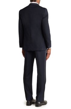 A sophisticated, refined contrasting trim adds a sleek style for a peak lapeled tuxedo suit. Blazer: 30" length (size 40R); pants: 10.5" rise, 32" inseam (size 34) Jacket has four-button cuffs; chest pockets; front pockets; interior pockets; vents Trousers have zip fly closure; front pockets; back pockets 68% polyester, 29% viscose, 3% elastane Dry clean Imported Model stats: 6'1" height, 32" waist. Model is wearing size 40R. Classic Tailored Blazer With Contrast Trim, Tailored Double Breasted Tuxedo Suit With Hidden Buttons, Tuxedo Suit With Flat Front, Tuxedo Style Business Pantsuit With Hidden Button Closure, Tailored Tuxedo Pantsuit With Suit Collar, Flat Front Tuxedo Suit In Suiting Fabric, Flat Front Tuxedo Suits In Suiting Fabric, Formal Double Breasted Tuxedo Suit, Tailored Tuxedo With Hidden Button Closure