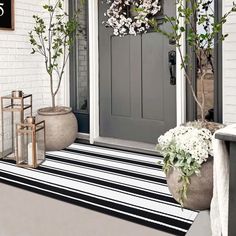 the front door is decorated with flowers and potted plants