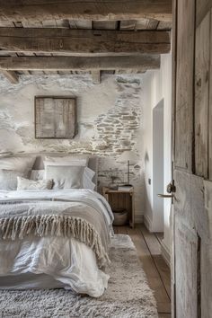 a bed sitting in a bedroom next to a wooden door on top of a white rug