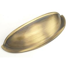 an oval brass plate on a white background