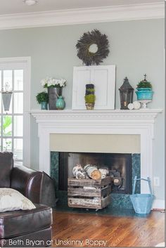 a living room filled with furniture and a fire place in front of a white fireplace