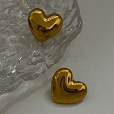 Fall in love with The Puffy Heart Earrings! These beautifully crafted earrings feature puffy heart designs that add a touch of charm to any outfit. Embrace your romantic side and add a touch of love to your style with these earrings. Perfect for any occasion! Details Material: Stainless Steel dipped in 18k gold Closure: Push Back Waterproof and tarnish resistant for everyday wear - but keep away from chemicals to avoid staining Size: Approximately 1" length, 1.25" width Earrings are final sale and can't be returned. Heart-shaped Clip-on Earrings For Valentine's Day, Heart-shaped Clip-on Earrings For Valentine's Day Anniversary, Valentine's Day Heart Shaped Clip-on Earrings For Anniversary, Valentine's Day Heart Shaped Clip-on Earrings, Heart Shaped Clip-on Earrings For Gift, Cute Gold Heart Earrings For Pierced Ears, Cute Gold Earrings With Heart Charm, Trendy Gold Heart Earrings With Heart Beads, Trendy Gold Heart Earrings With Beads