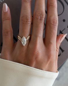 a woman's hand with a diamond ring on it