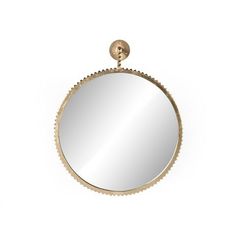 a round mirror hanging on the wall with a hook in it's center and an attached ball at the top