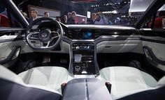 the interior of a car is shown with people looking at it and onlookers in the background