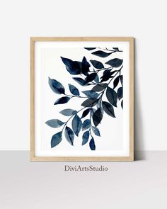 a framed print with blue leaves on it