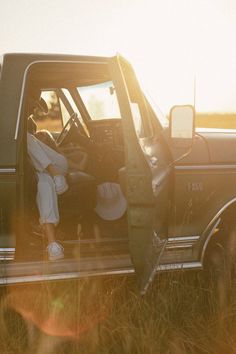 a woman sitting in the back of a pickup truck