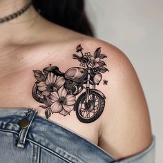 a woman's shoulder with a motorcycle and flowers on it