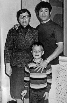 an old black and white photo of two men and a boy standing next to each other