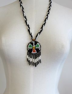 Vintage Navajo Wedding Basket Thunderbird Design Glass Beads Necklace Pendant. Backed by leather. Dimensions of necklace: Width 50mm (2") Height 75mm (3" including drops) Length 24" Please check out my other designs and vintage pieces here: https://www.etsy.com/uk/shop/YouGotTheSilverUK  Click on customise for any custom queries or bespoke pieces. Adjustable Medallion Beaded Necklaces For Festivals, Bohemian White Jewelry With Black Beads, Southwestern Necklaces With Dangling Beads And Adjustable Fit, Southwestern Necklaces With Dangling Beads, Southwestern Necklace With Dangling Beads And Adjustable Fit, Southwestern Style Adjustable Teardrop Necklace, Southwestern Festival Jewelry With Large Beads, Southwestern Style Large Beads Jewelry For Festivals, Southwestern Style White Jewelry With Dangling Beads