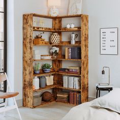 an open bookcase in the corner of a room