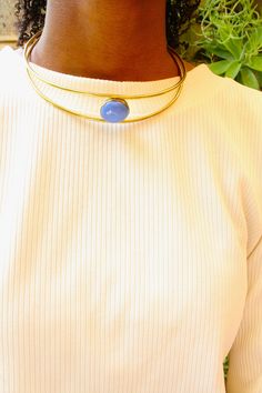 Handcrafted in Nairobi, Kenya. Crafted with brass and adorned with a blue stone bead. Has an open back and has adjustable width. Choker width measures at 13.5 cm approx. Metal Beaded Choker Necklace, Adjustable Round Trendy Choker, Trendy Adjustable Round Choker, Adjustable Round Choker For Festivals, Adjustable Metal Choker With Round Beads, Unique Brass Choker Necklace, Gold-tone Brass Choker Jewelry, Unique Adjustable Brass Choker, Vintage Brass Choker Necklace