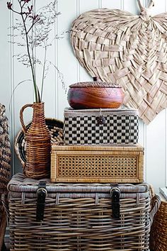 wicker baskets stacked on top of each other in front of a heart shaped wall