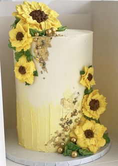 a white and yellow cake with sunflowers on it