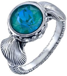 a ring with a blue topazte stone in the center and leaves around it