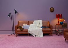 a living room with purple walls and pink carpet