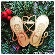 an ornament hanging from a christmas tree with two pairs of shoes on it