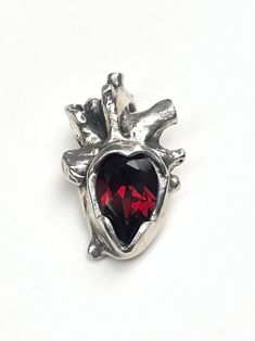 "Sterling silver anatomical heart with a gorgeous deep red garnet.  This pendant comes on an 18\" silver chain. Made to order. Please expect 1-2 weeks processing time." Anatomical Heart Jewelry, Anatomical Heart Pendant, Anatomical Jewelry, Red Gemstone Jewelry, Heart Anatomy, Alt Clothes, Anatomical Heart, Chatelaine, Jewelry Inspo