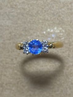 Unheated Burmese Sapphire with Natural Diamond 18K Solid Yellow Gold. Weight of sapphire 0.88ct. Weight of natural diamond 4pcs-0.10ct. Length and width of sapphire  5.2x5.2mm. Length and width of sapphire and diamond 9x5.2mm. Total weight of ring 2.1gm. Gemstone -  Unheated Burmese sapphire   Transparency -  Transparent  Could  -  Sky Blue  Clarity - VVS  Treatments  -  None  Hardness   -   9 Origin of sapphire Mogok Myanmar (Burma) Sparkle and look blue diamond. Micro chip on the surface. Ring size 6 Condition -Brand New Certificate of Guarantee Final fixed price  Made in Myanmar (Burma) Ready to ship in next day. Please feel free to message me for any questions related to the piece. Dazzling Yellow Gold Sapphire Ring With Brilliant Cut, Brilliant Cut Sapphire Diamond Gemstones, Luxury Sapphire Gemstones With Round Cut, Luxury Sapphire Gemstones With Vvs Clarity, Round Cut Sapphire Diamond Gemstones, Dazzling Yellow Gold Sapphire Ring, Blue Sapphire Ring With Single Cut Diamonds, Brilliant Cut Round Sapphire Gemstones, Luxury Sapphire Gemstones With Brilliant Cut