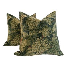 two green floral pillows on white background