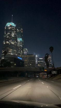 the city skyline is lit up at night