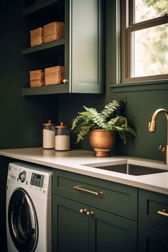 a washer and dryer in a green kitchen