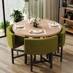 a dining table with four chairs and plates on it in front of a large window