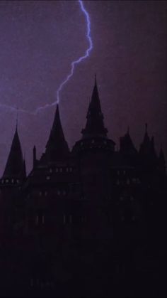 a lightning bolt is seen in the sky over a castle